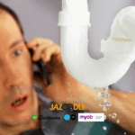 Leaking pipe with concerned person on phone.